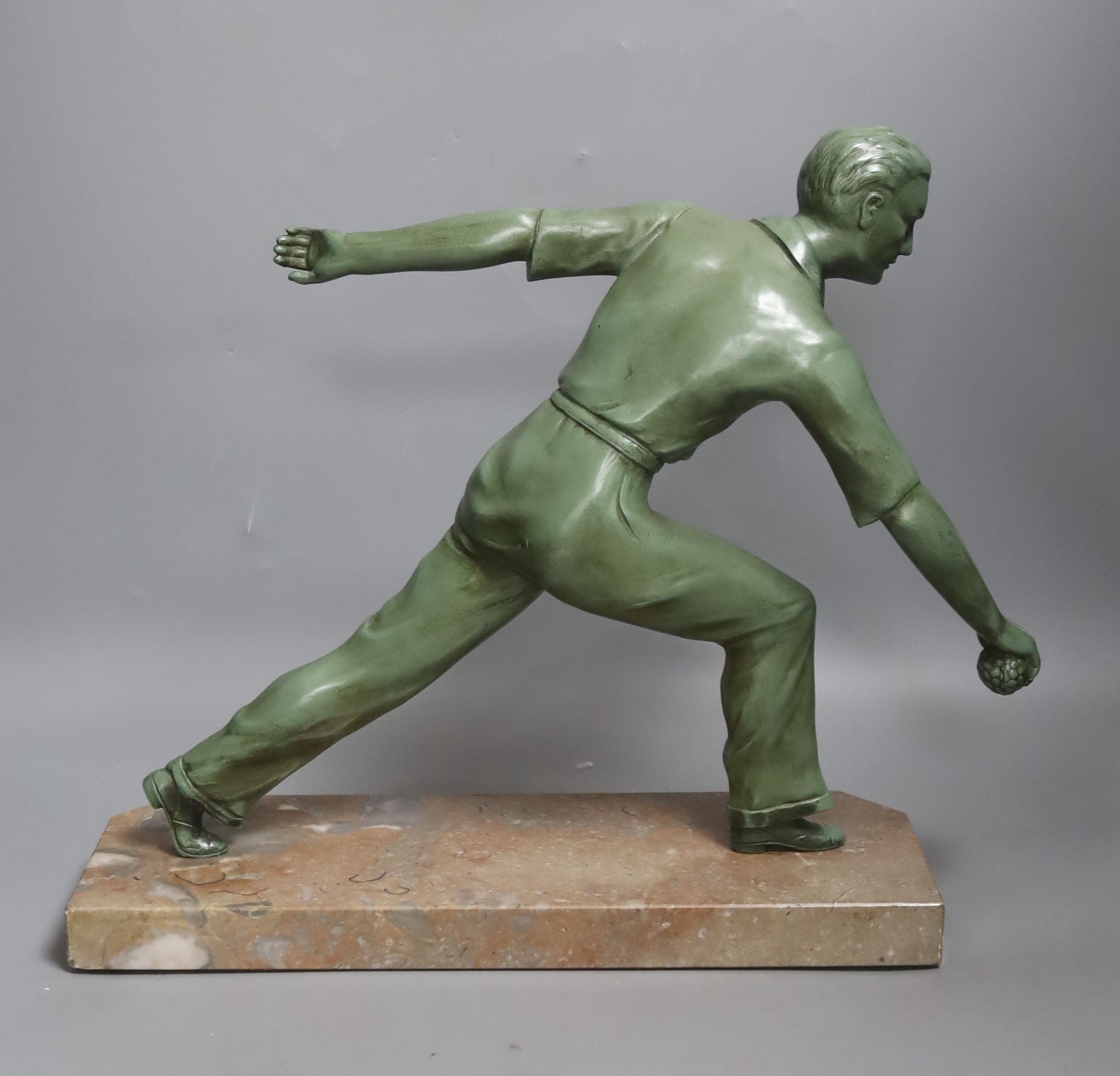 An Art Deco model of a gentleman playing boules. Marble base with plaque reading ‘Les boulistes de l-A.S.P.T.T a leur President’ - 33.5cm